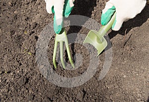 Woman working in your garden - preparing the soil for raised beds