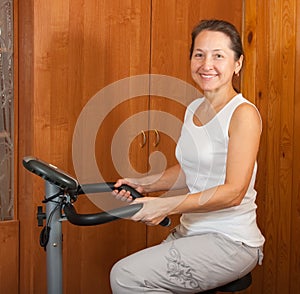 Woman workout on stationary bicycle