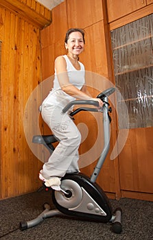 Woman workout on stationary bicycle