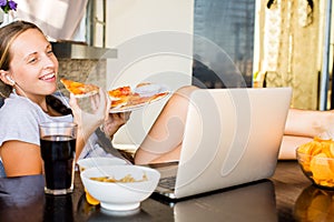 Woman works at the computer and eating fast food. Unhealthy Life