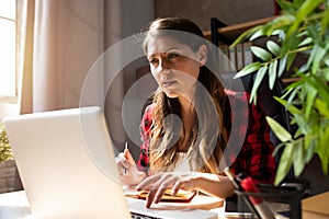 Woman works at home with laptop. concept of smart work photo