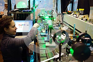 Woman works with laser educational installing,