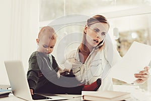 A Woman Works During Maternity Leave At Home. photo