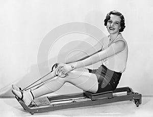 Woman works out on rowing machine