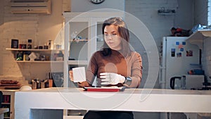 Woman works with a tablet, wearing robotic prosthesis, close up.