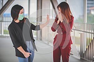 Woman worry and fear Female friend  cough  in medical mask outdoor. keep distance. Stop corona virus