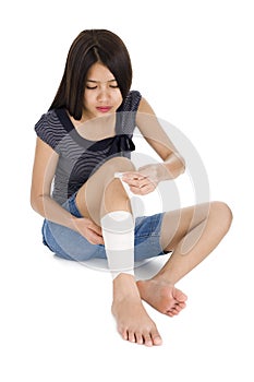 Woman wrapping a bandage around her leg