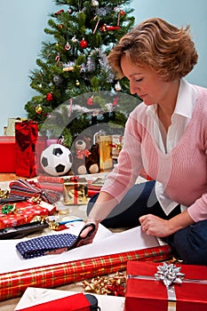 Woman wrapping Christmas presents.