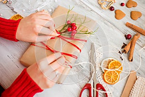 Woman wrapping gift on table