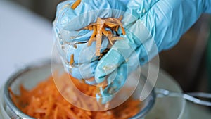 Woman wring out Grated carrots for cooking