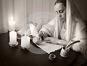 Woman write letter on vintage paper for writing on wooden table