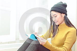 Woman write notes near the window, relaxing lifestyle