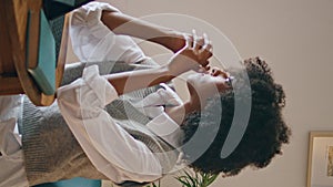 Woman writer typing laptop in cafe close up. African girl at computer vertical