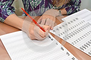 The woman writes letters in copy-books with calligraphical handwriting