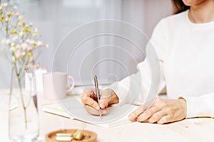 Woman writes in notebook