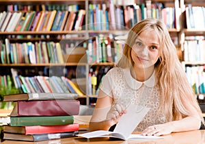 Woman writes notes in the library