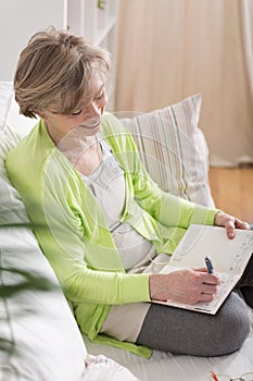 Woman writing in agenda