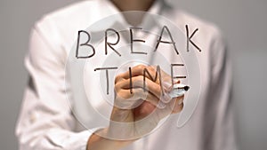 Woman writing Break Time on transparent screen. Businesswoman write on board.