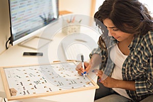 Woman writing on calendar