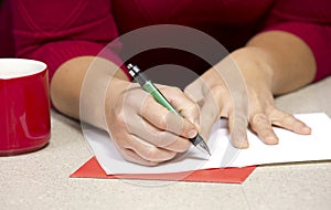 Woman writing Christmas card