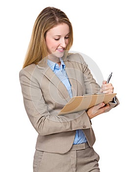 Woman writing on clip-board