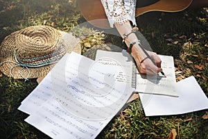 Woman writing down some lyrics