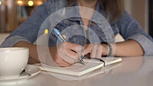 Woman writing in journal, diary