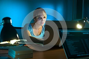 Woman Writing On Laptop Computer Late At Night