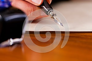 Woman writing a letter with pen and ink