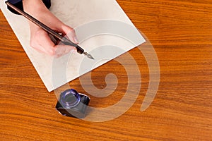 Woman writing a letter with pen and ink