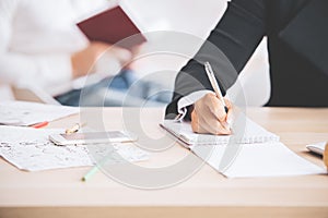 Woman writing in notepad