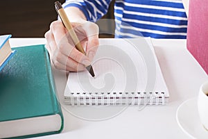 Woman writing in notepad