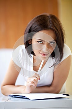 Woman writing on notepad to do list at home