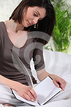 Woman writing with pen
