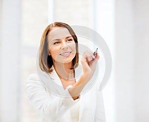 Woman writing with pen in the air