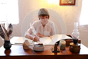 Woman writing with quill pen