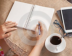 Woman writing shot memories note on white paper with relaxing ti