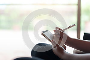 Woman writing on small notepad