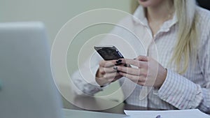 Woman writing sms on smartphone