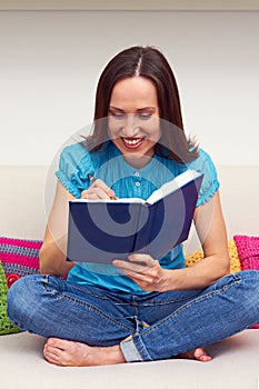 Woman writing something in the daybook