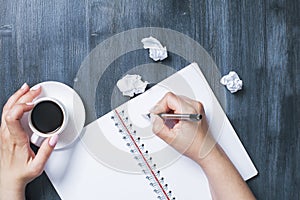 Woman writing in spiral notepad