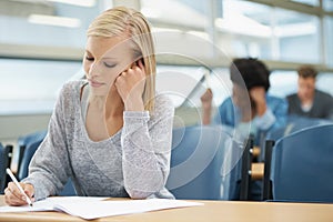 Woman, writing test or college student with notes in class, classroom or lecture for exam or education. University