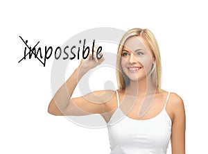 Woman writing the word (im)possible in the air