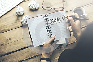 Woman written goals text on notepad