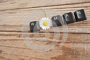 WOMAN wrote with keyboard keys on wooden background