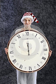 Woman with xmas hat and midnight clock