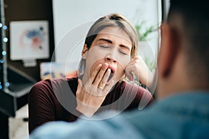 Woman Yawning During Boring Conversation With Partner