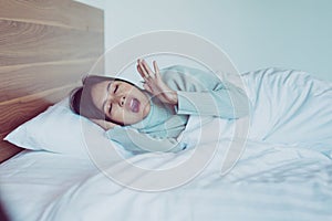 Woman yawning on her bedroom and tired sleepy,Symptoms and sleepiness