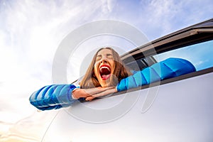 Woman yawning looking out the car window