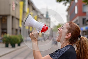 Woman yelling into a bullhorn photo